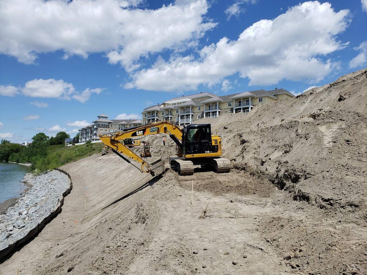 Pelle sur un talus de sable près de la rivière